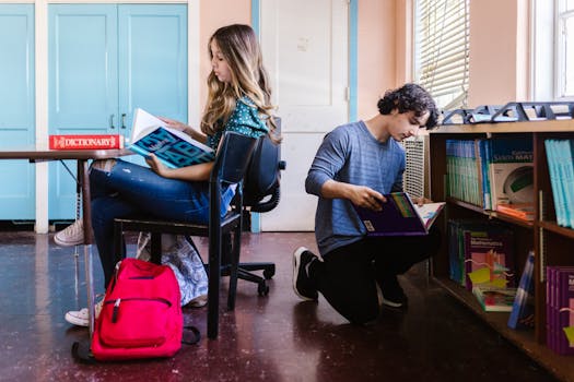 Two students engrossed in reading and researching for their school projects./pexels-photo-8419156-8419156